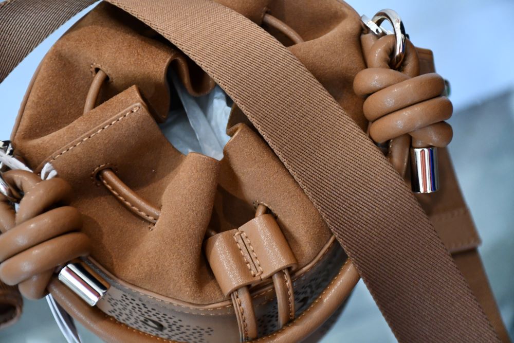 top of Ted Baker Laser Cut Out Brown Suede Bucket Bag unused