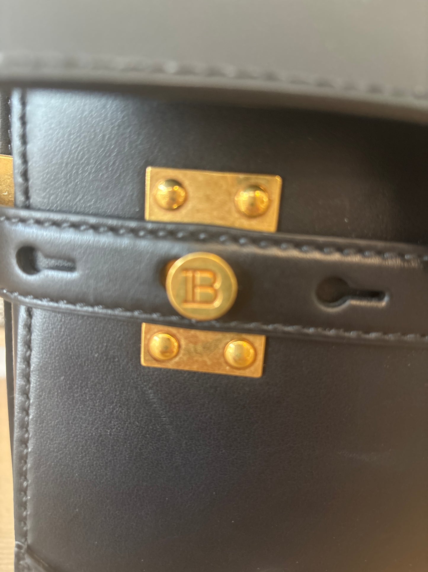 Gold tone hardware featuring Balmain plaque 