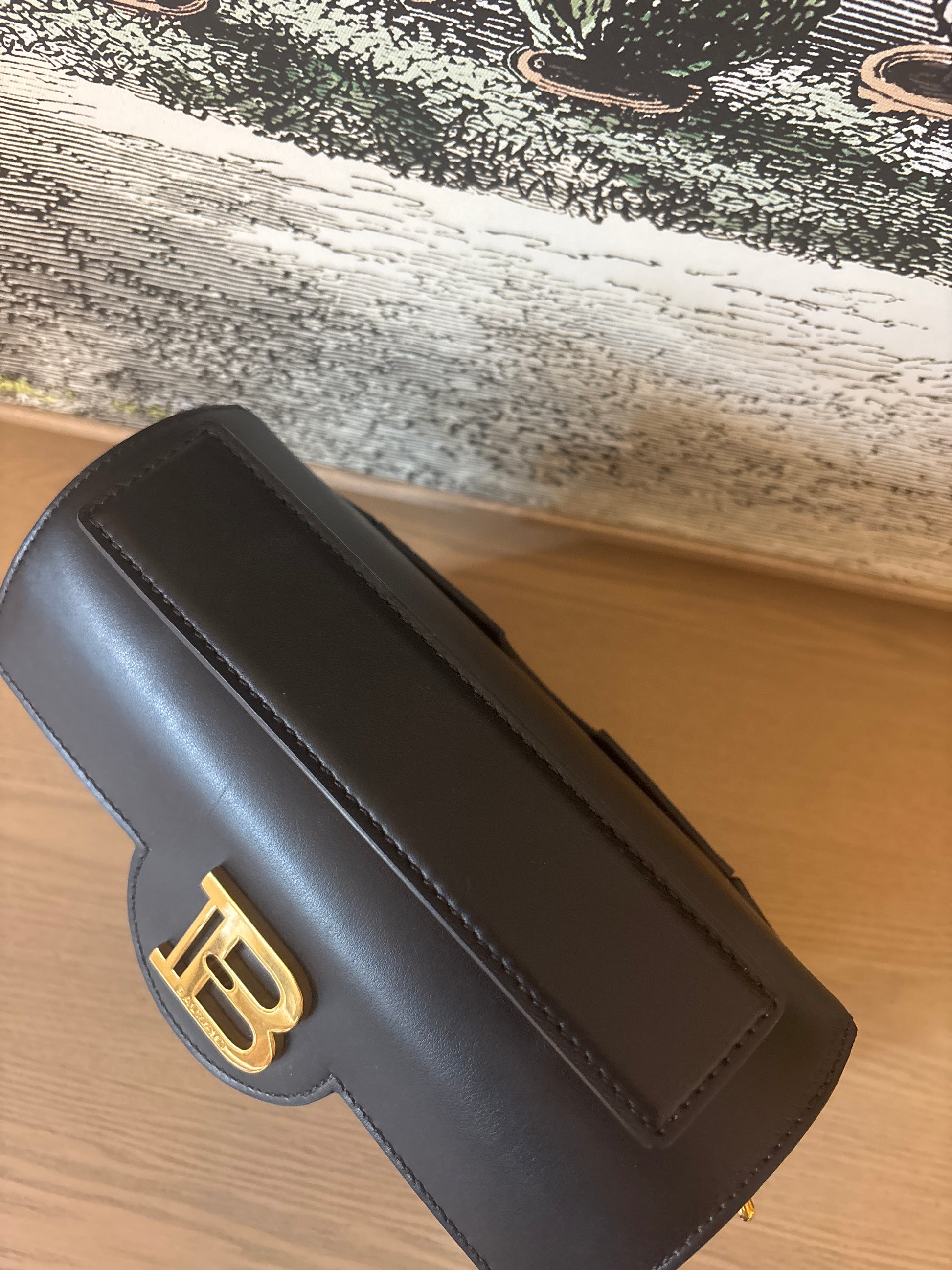 Preowned designer BalmIn showing smooth calfskin top handle 