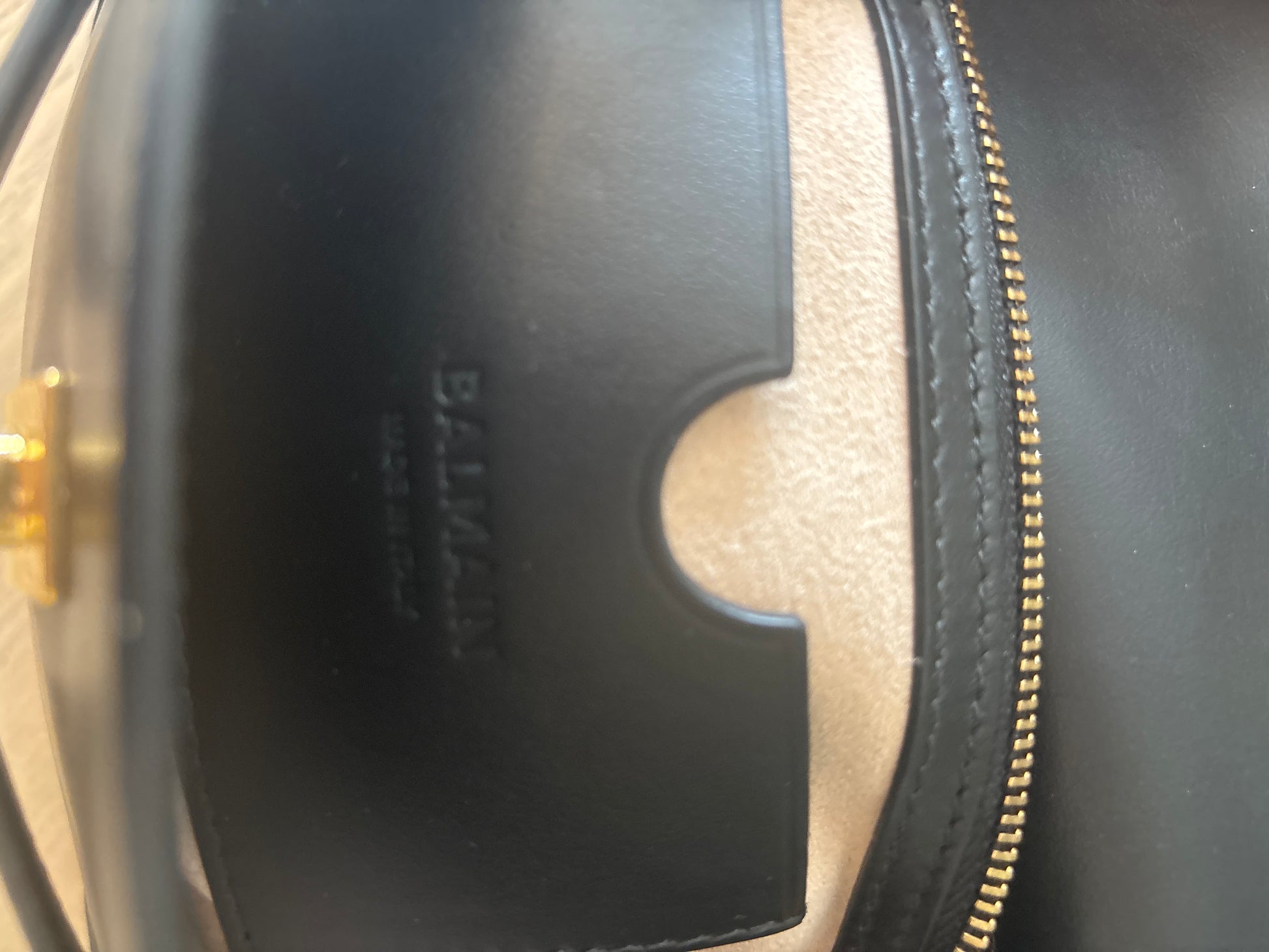 Balmain interior leather pockets showing the branded logo 