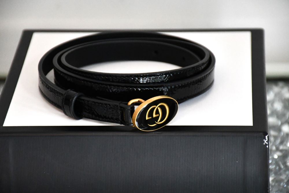 preowned Gucci Black leather belt with a gold buckle on a white box