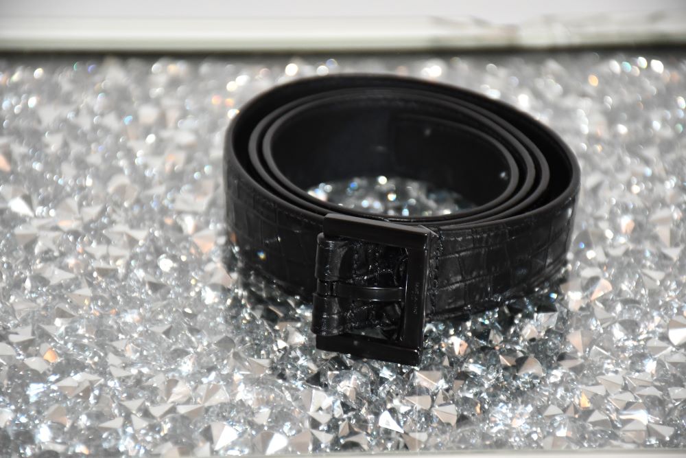 preowned St Laurent long Black Leather Crocodile Effect Belt on silver table