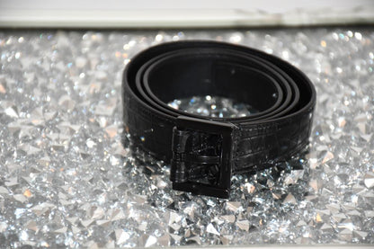 preowned St Laurent long Black Leather Crocodile Effect Belt on silver table