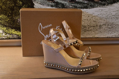 preloved Louboutin Cataclou 110 Patent Nacre Gold Sandals infront of Louboutin box