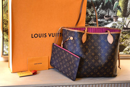 Pre owned Louis Vuitton MM Neverfull Mongram Bag  in front of orange LV box