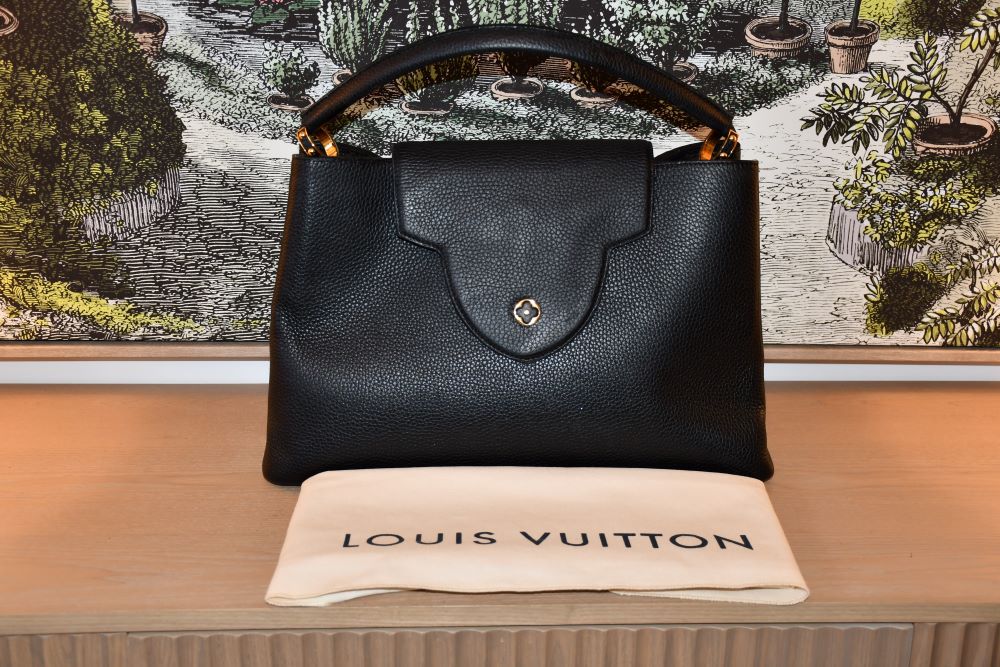 pre owned Louis Vuitton Black Taurillon Capucines GM Bag behind Louis Vuitton dustbag