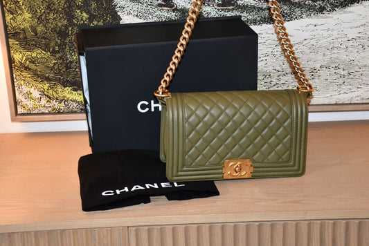 pre owned Chanel Small Boy Olive Green Caviar Lambskin Bag infront of box